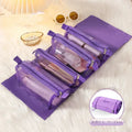 Purple travel organizer bag with four expanded compartments holding personal items on a bed.