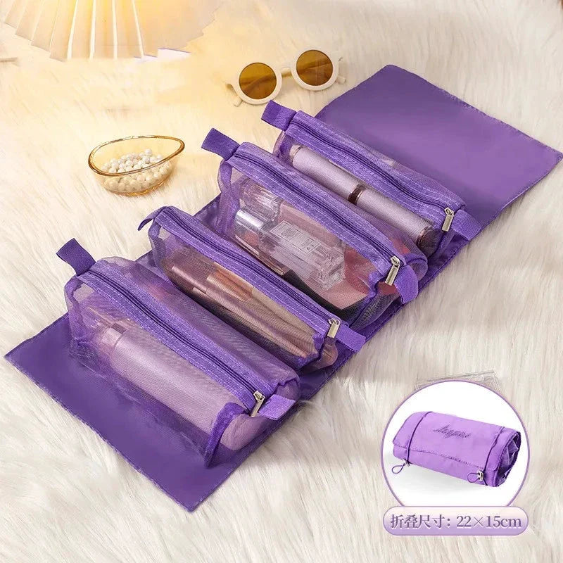 Purple travel organizer bag with four expanded compartments holding personal items on a bed.