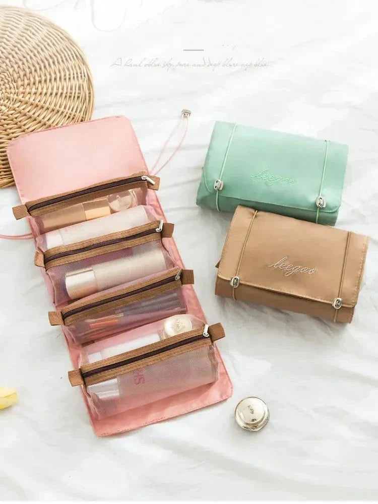 Pink travel organizer bag expanded on a bed, with folded green and beige organizers placed beside it.